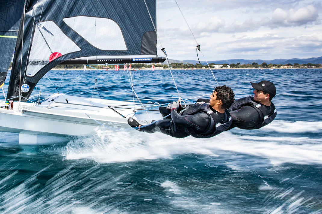 Two men in Magic Marine harnesses on a boat